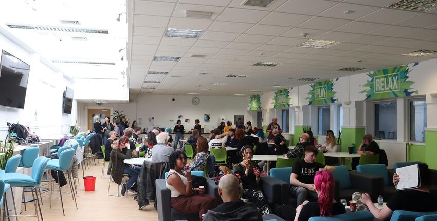 Students and staff from New College Lanarkshire sitting in the Student Common Room in the St Andrews Building of the Unviersity of Glasgow