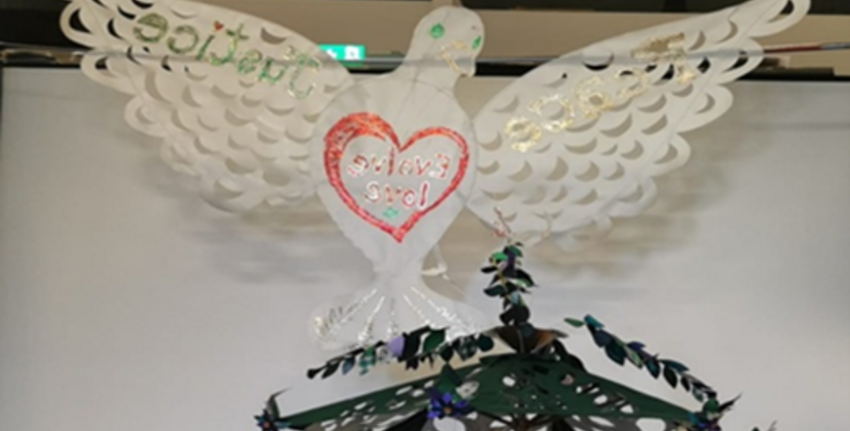 A paper dove with a red love heart on its breast